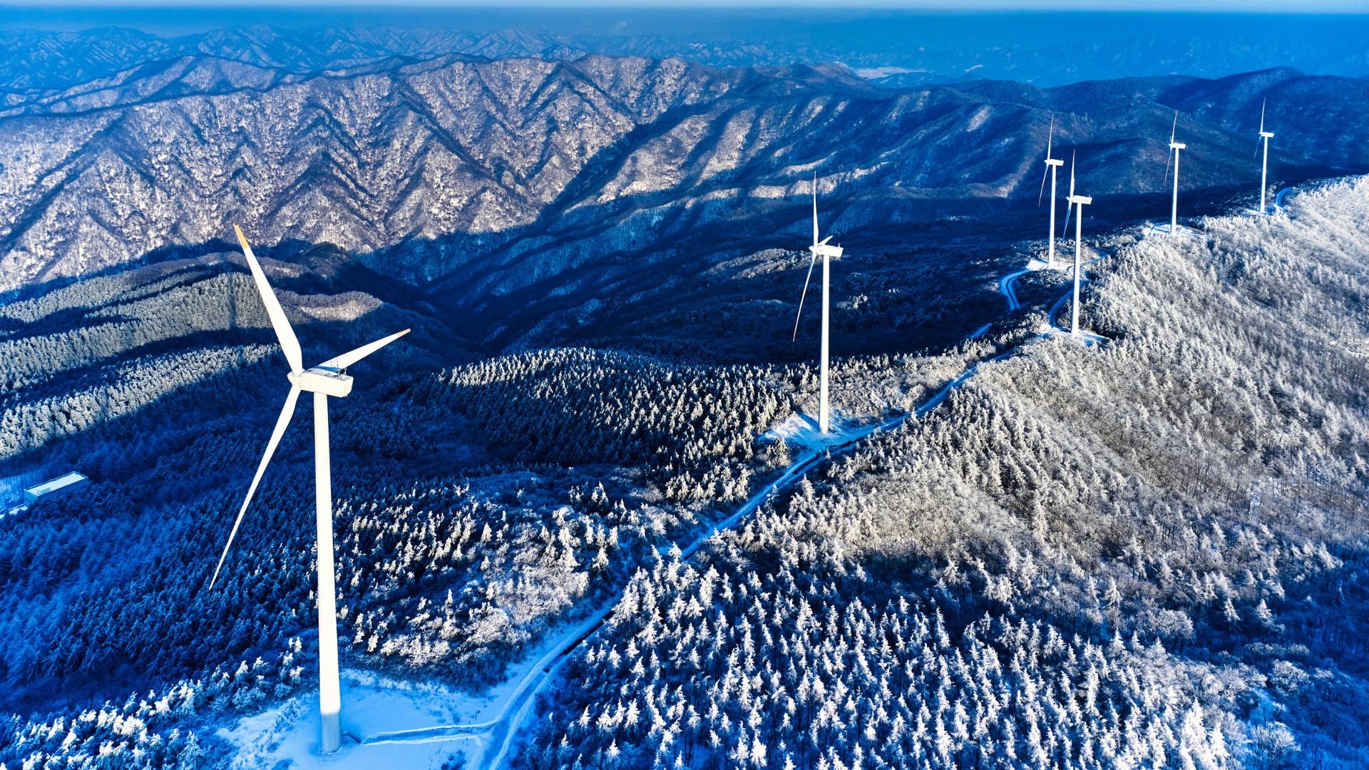 Wind farm on a snow-covered mountain.