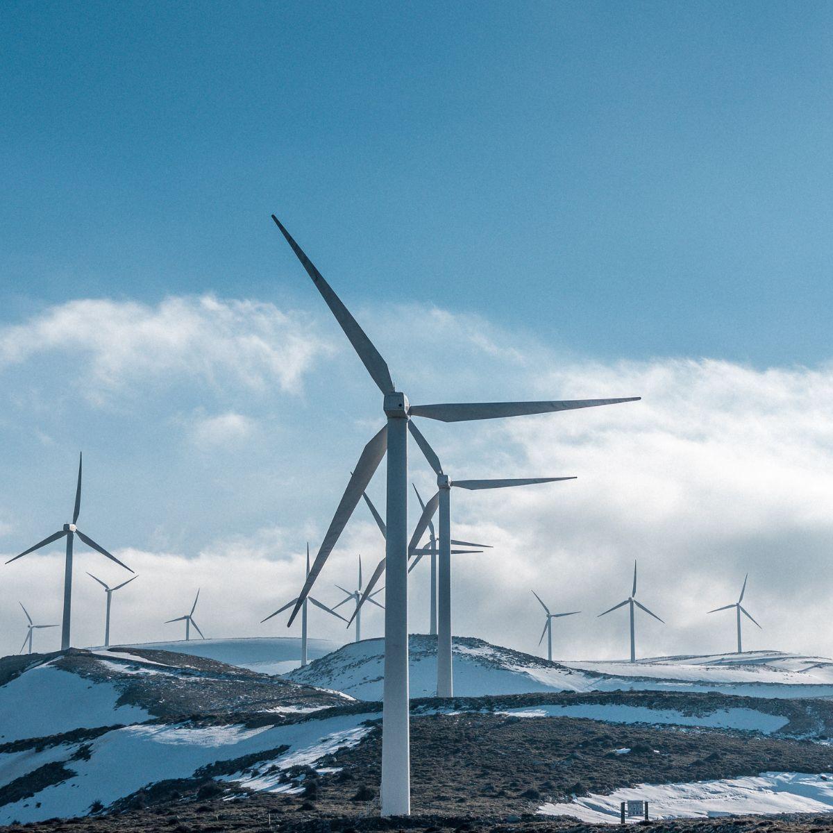 Wind farm on a mountain with snow.