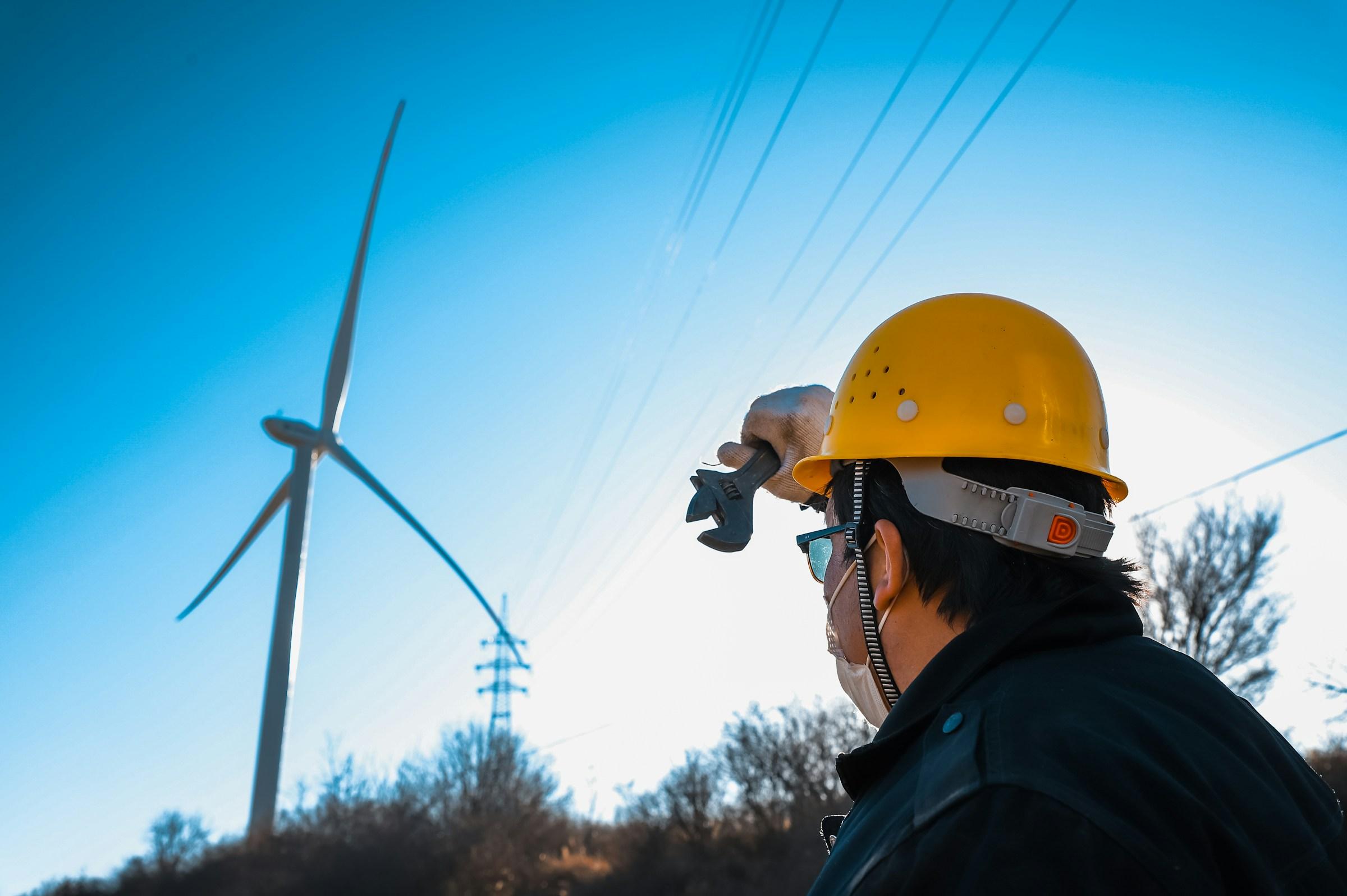Wind turbine technician in a safety helmet during an inspection
